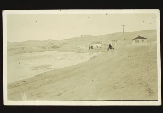 Flooded creek beside a dirt road near Eastend